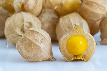 Cape Gooseberry (Physalis Peruviana) close up photography of the latern fruits in a white floor with some laterns fruit behind.