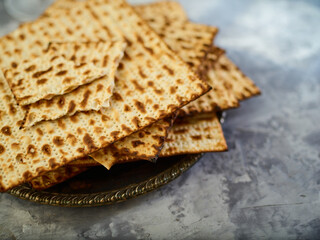 Matzah is kosher Jewish bread. An important dish in the celebration of the Jewish Passover. Long traditions, religion, rituals. Close-up. Careful viewing. Light background.