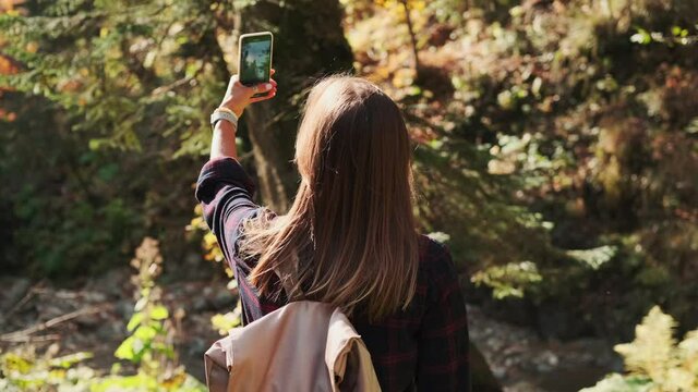 hiker is photographing nature by smartphone