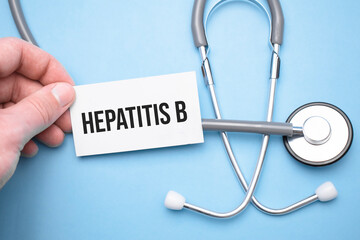 the doctor's hands holds a business card with the text of Hepatitis b with one hand and the other...