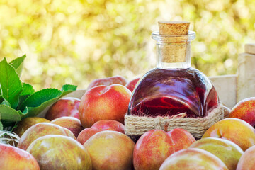 Bottle of Plums juice with a lot of plums in a wood box crate