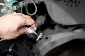 Technician remove Brake hose from brake caliper of the car in system check