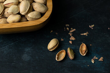 Closeup shot of pistachio in a wooden bowl