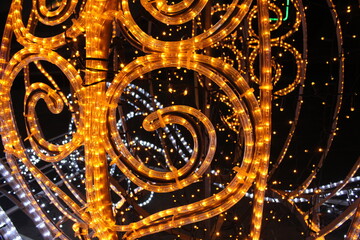 yellow lights on a dark black background. New Year's Eve Christmas background. Festive lighting