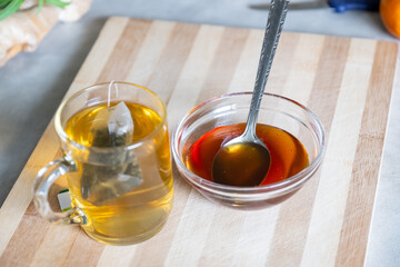 Raw honey and glass mug of tea