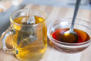 Raw honey and glass mug of tea