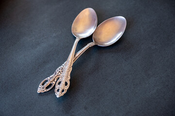 old spoons on a black background