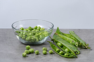 Bowl with fresh peas taken from their pods