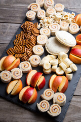 Fun kids snack tray with pretzels, fruit, sandwich rolls and more
