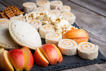 Fun kids snack tray with pretzels, fruit, sandwich rolls and more