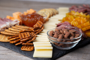 Full platter with meats, cheese, nuts, crackers, olives and an apricot spread