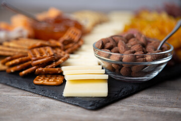 Full platter with meats, cheese, nuts, crackers, olives and an apricot spread