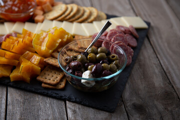 Full platter with meats, cheese, nuts, crackers, olives and an apricot spread