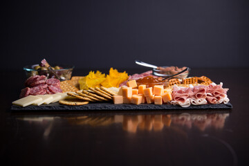 Full platter with meats, cheese, nuts, crackers, olives and an apricot spread