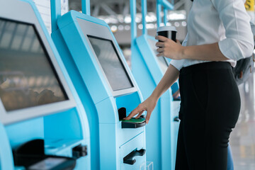 Smart asian female business scan passport check in with automatic machine airport terminal safety...