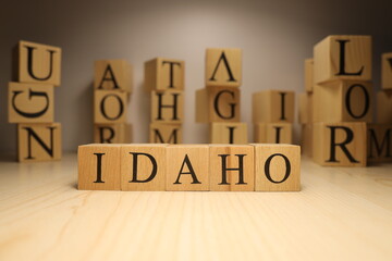 The word Idaho was created from wooden letter cubes. Cities and words.