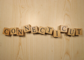 The word Connecticut was created from wooden letter cubes. Cities and words.