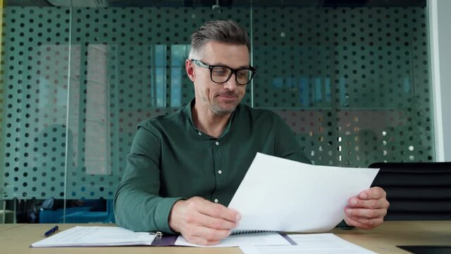 Mature business man ceo executive talking to web camera on video conference call training, having virtual meeting remote working showing financial report, making presentation in office. Webcam view