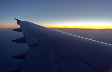 Fototapeta na wymiar View from the plane at sunrise