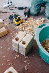 carpenter working in his workshop with wooden tools
