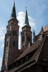 Fototapeta na wymiar Back of the towers of the medieval Church of St. Sebald (St. Sebaldus) in Nuremberg, Germany, seen over rooftops