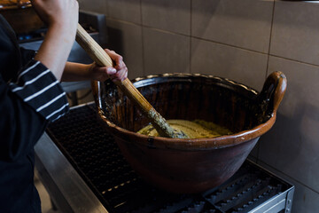 cooking Mexican Mole food in a traditional clay pot in Mexico