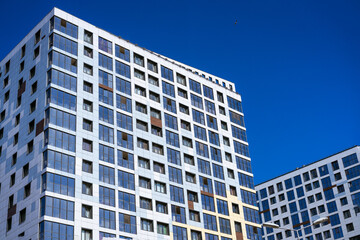 beautiful facades of high-rise buildings against the blue sky on a sunny day