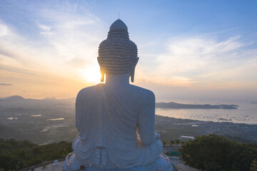 aerial view glare of sunrise on the shoulder of Phuket big Buddha.Phuket Big Buddha is one of the island most important and revered landmarks on the island..image for travel and culture concept.. © Narong Niemhom