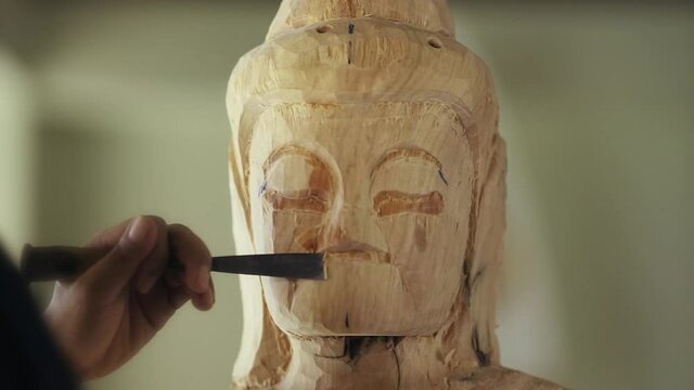 Full HD, Asia craftsman professional use chisel carving face buddha statue in workshop. Artist engrave wood. Carpentry woodwork. Handcraft carved. Selective focus.