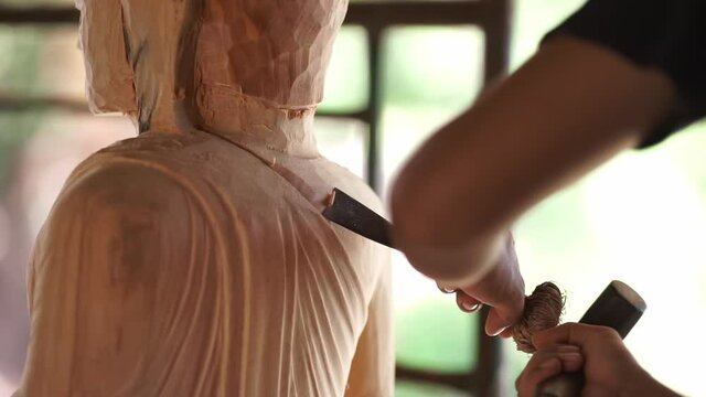 Full HD, Asia craftsman professional use chisel carving wood handmade buddha statue in workshop. Artist engrave wood. Carpentry woodwork. Handcraft carved. Selective focus.