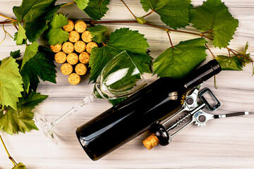 wine corks are laid out in the form of a grape brush grape branches a wine corkscrew a bottle of...