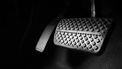 Man foot and accelerator and brake pedal inside the car or vehicle and copy space which black color...