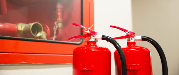 Fire extinguisher, Close-up red fire extinguishers tank with fire hose cabinet in the building concepts of protection and prevent for emergency and safety rescue and fire training.