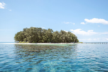 An island in the middle of clear water ocean at Karimun Jawa
