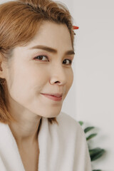 Fototapeta premium The nude face of Asian woman model prepare to be applied makeup from the artist.