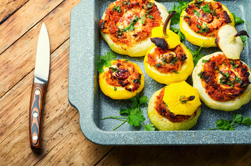 Baked stuffed patisson on rural wooden table