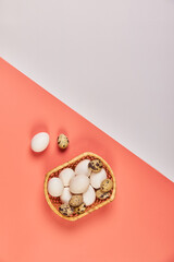 Eggs for Easter in a basket pink white background
