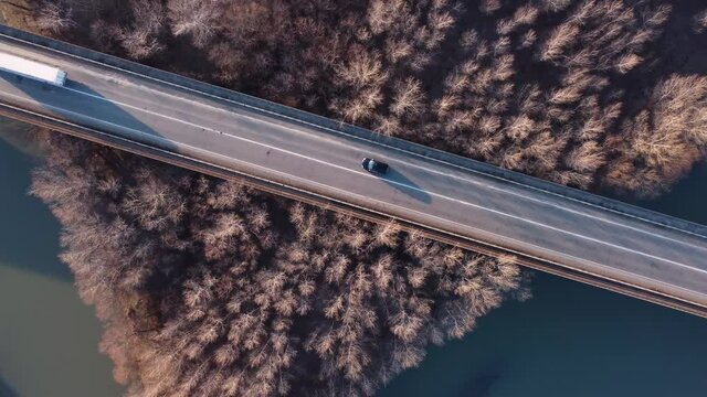 Cars on the brigde over the river and forest