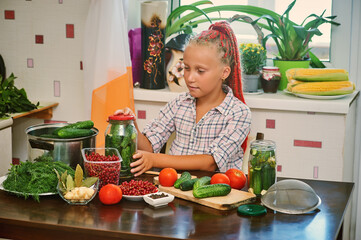 The child is engaged in canning vegetables at home. Procurement of products.