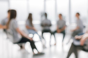 background image of a group of young people sitting in a circle