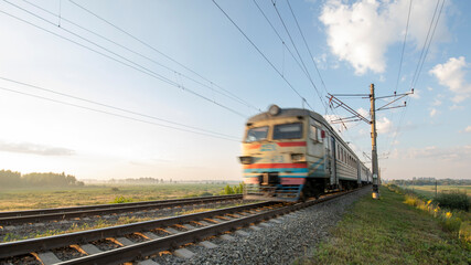 Fototapeta na wymiar A passenger train on the railway is moving at high speed