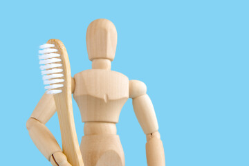 wooden toothbrush on the background of a wooden mannequin