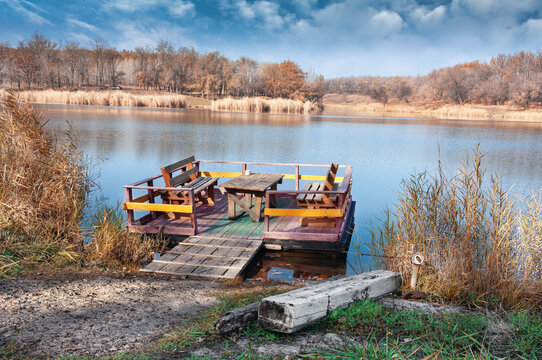 Wooden raft made of boards and beams for relaxing on the lake 