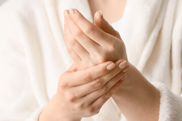 Woman applying shea butter onto hands, closeup