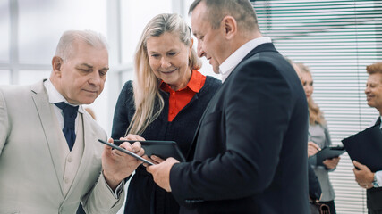close up . group of employees standing near the office window.