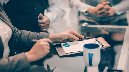 close up. businesswoman making notes on a financial chart.