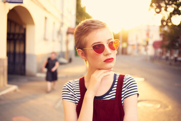 short haired woman wearing sunglasses outdoors walk lifestyle