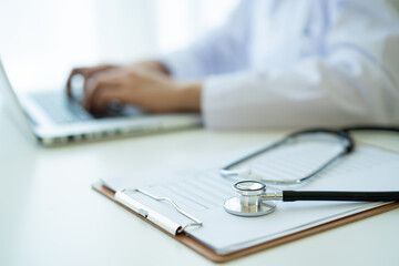 Medical stethoscope left in the doctor office in hospital close up with copy space. 