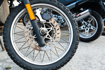 The front wheel of a powerful sports bike.