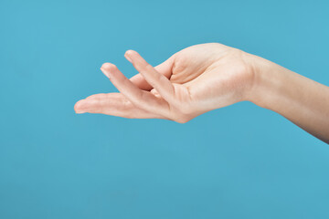female hand skin care cream blue background close-up